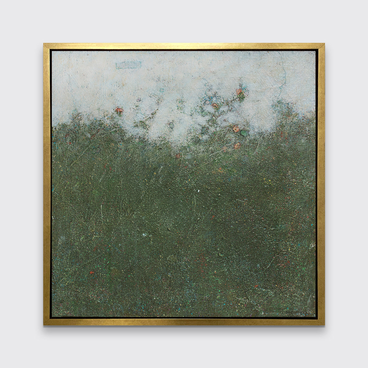 A dark green abstract landscape print in a gold floater frame hangs on a white wall.