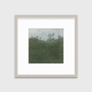 A dark green abstract landscape print in a silver frame with a mat hangs on a white wall.