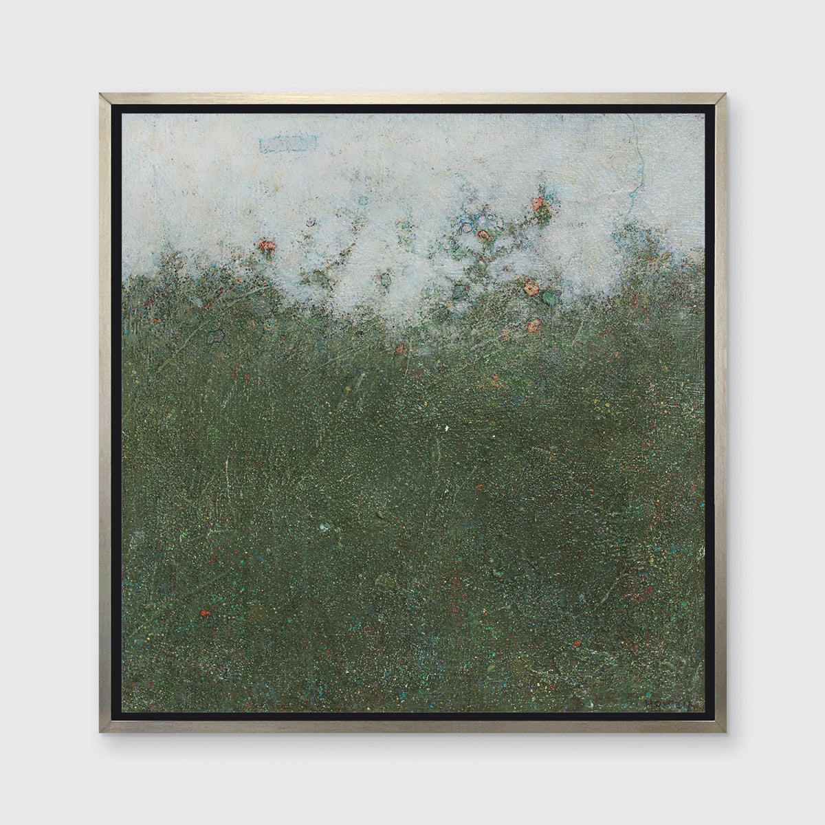 A dark green abstract landscape print in a silver floater frame hangs on a white wall.