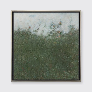 A dark green abstract landscape print in a silver floater frame hangs on a white wall.