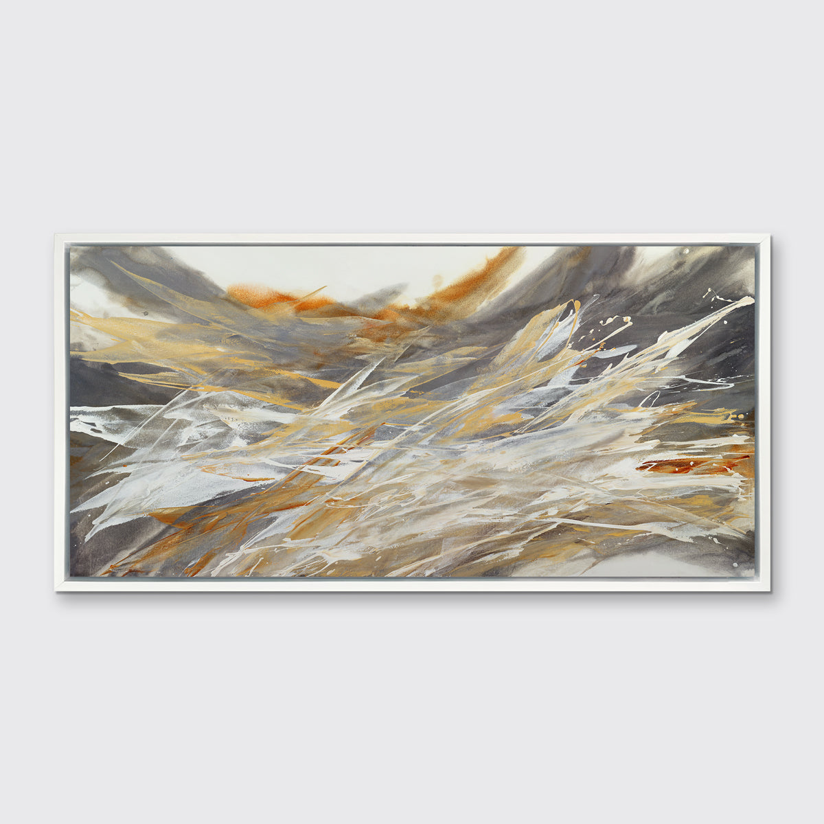 A gold, beige, white and grey abstract print in a white floater frame hangs on a white wall.