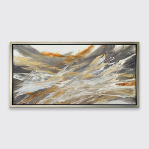 A gold, beige, white and grey abstract print in a silver floater frame hangs on a white wall.