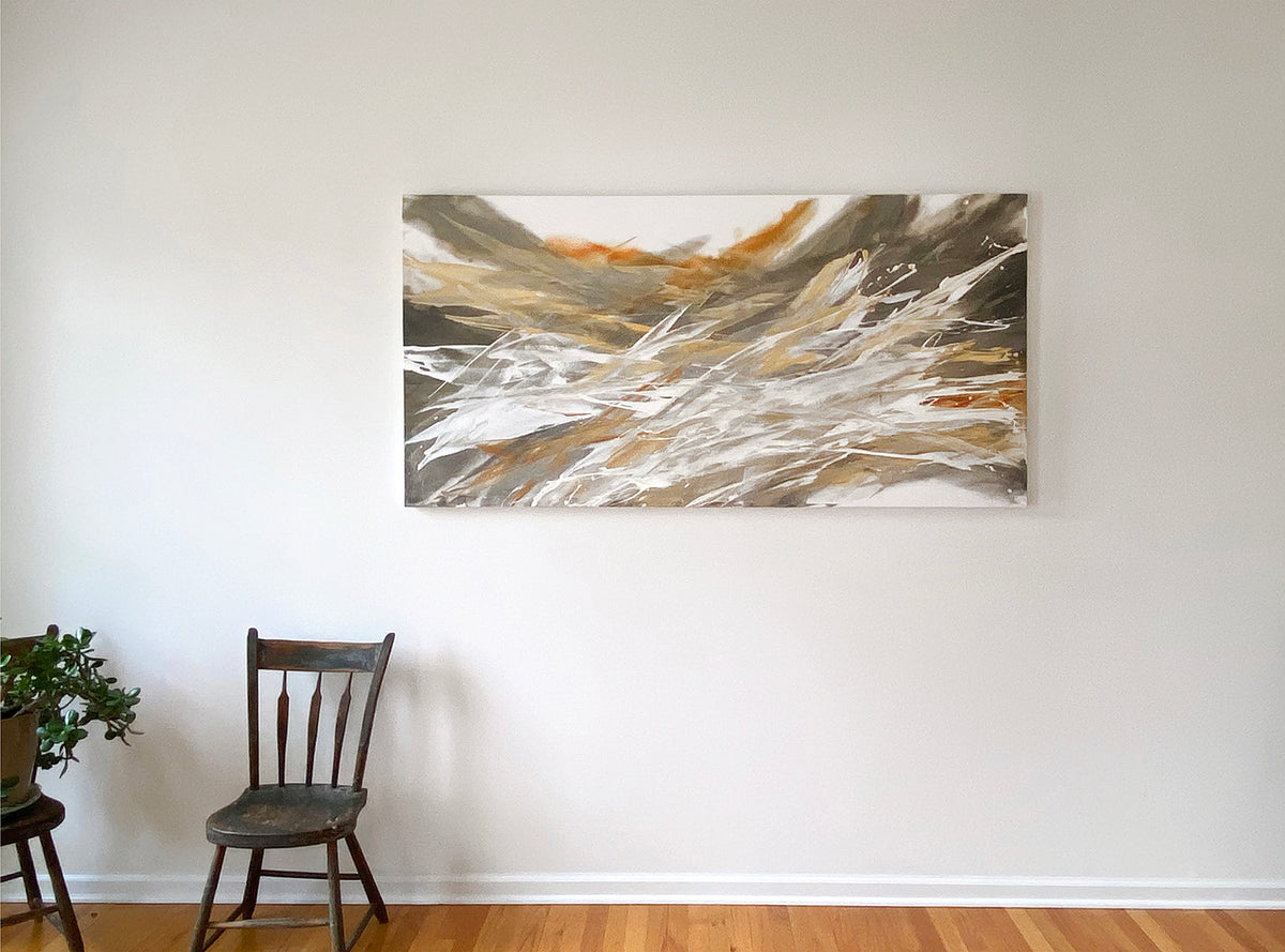 An orange, white, and black abstract painting by Teodora Guererra hangs on a white wall.