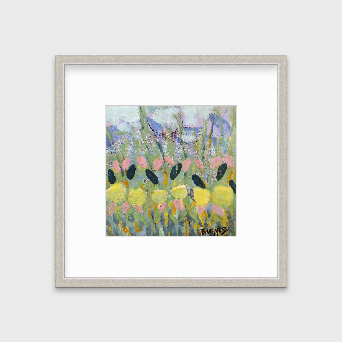 A green, yellow and pink abstract floral print in a silver frame with a mat hangs on a white wall.