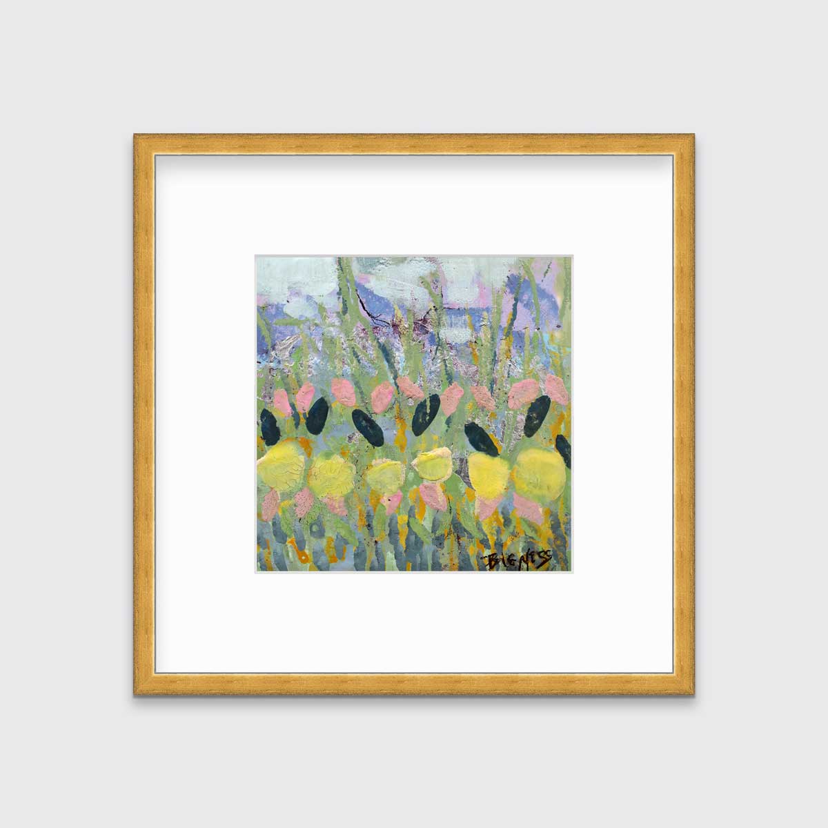 A green, yellow and pink abstract floral print in a gold frame with a mat hangs on a white wall.