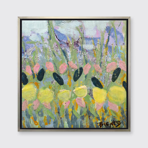 A green, yellow and pink abstract floral print in a silver floater frame hangs on a white wall.