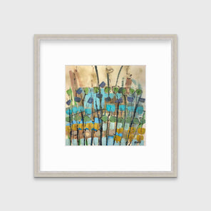 A blue, green, gold and brown abstract floral print in a silver frame with a mat hangs on a white wall.