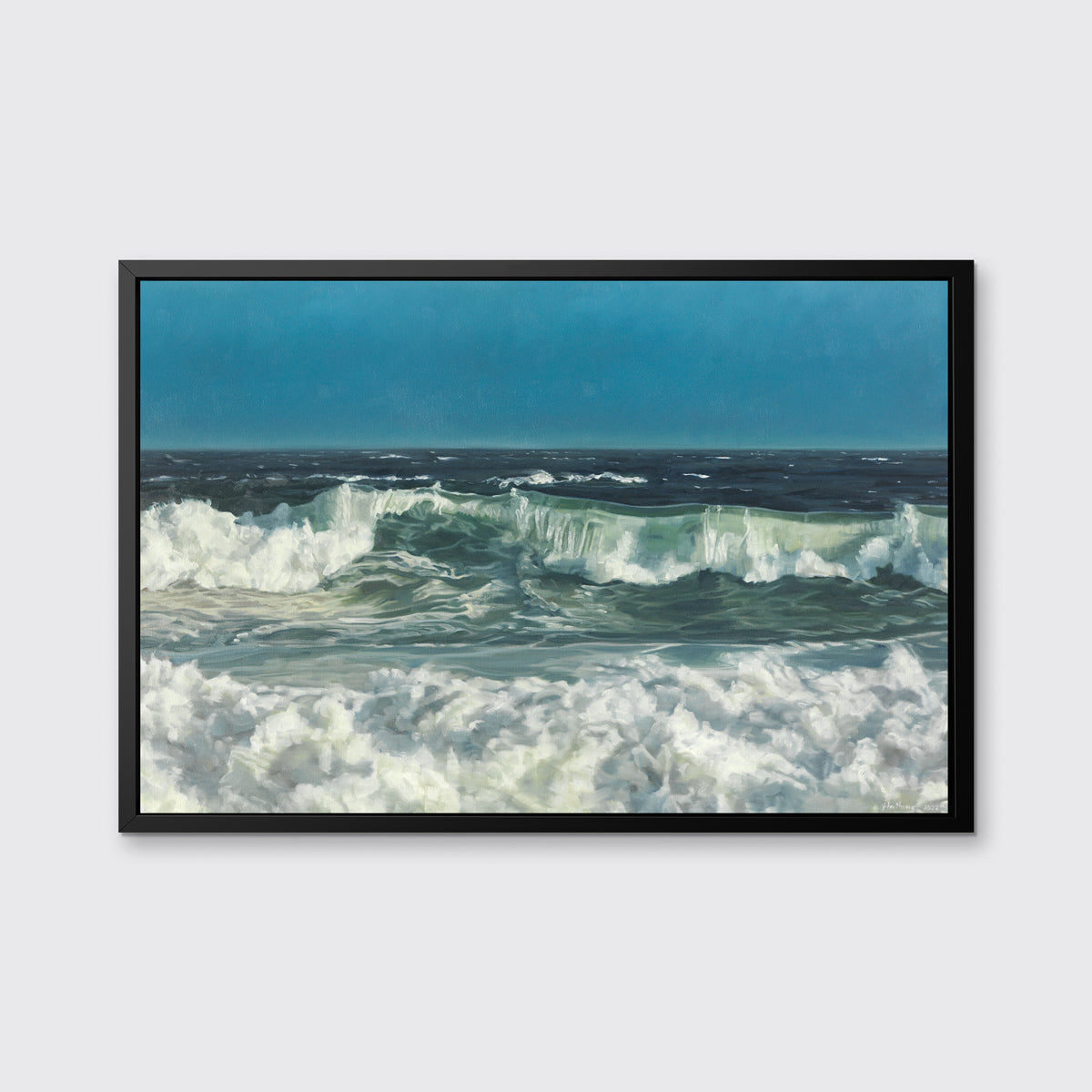 A blue, green and white abstract ocean waves print in a black floater frame hangs on a white wall.