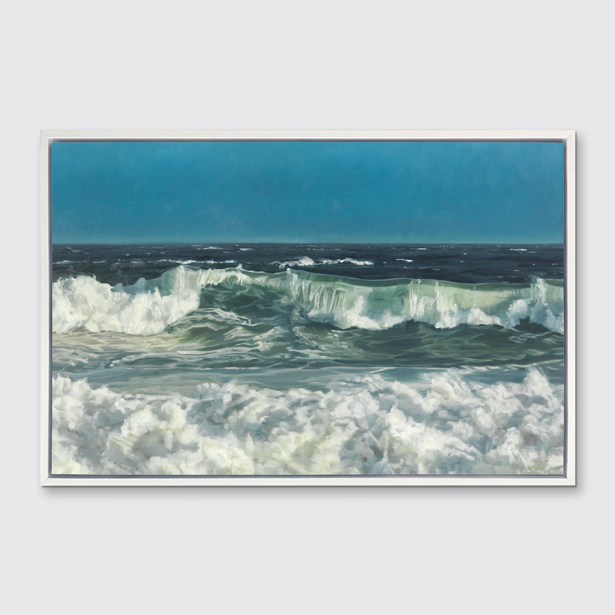 A blue, green and white abstract ocean waves print in a white floater frame hangs on a white wall.