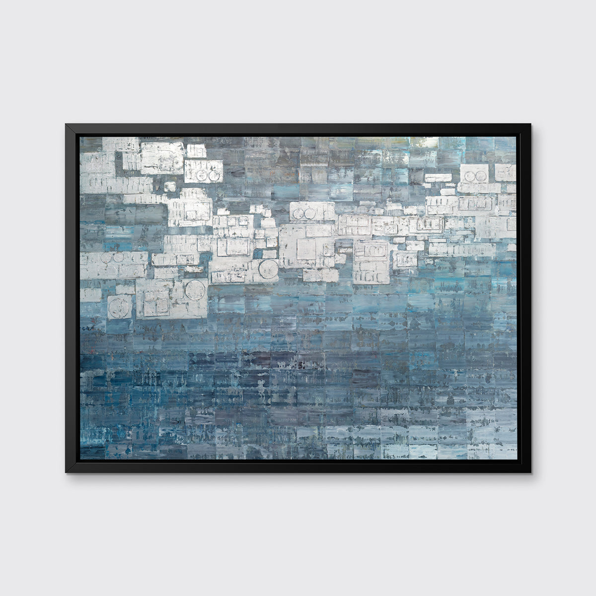 A blue, white and grey abstract print in a black floater frame hangs on a white wall.
