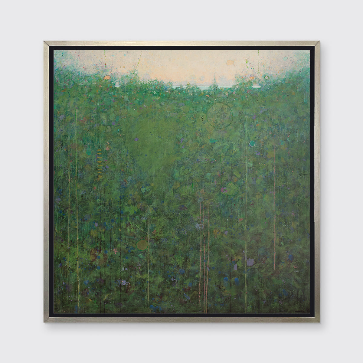 A green and blue abstract landscape print in a silver floater frame hangs on a white wall.
