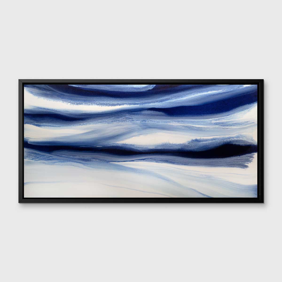 A dark blue and white abstract print in a black floater frame hangs on a white wall.