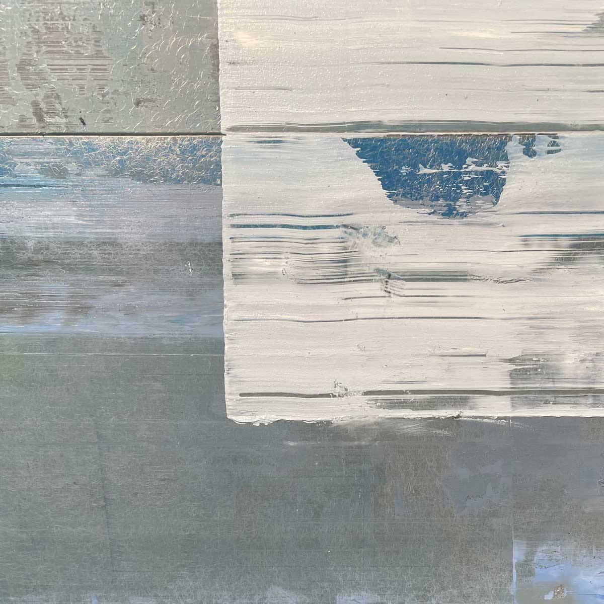 A close up detail image of white paint over aluminum sheets from an abstract painting by Ned Martin. 