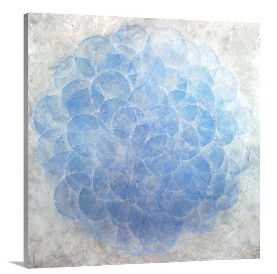 A side-angle view of a blue, white and silver abstract geometric print on canvas.