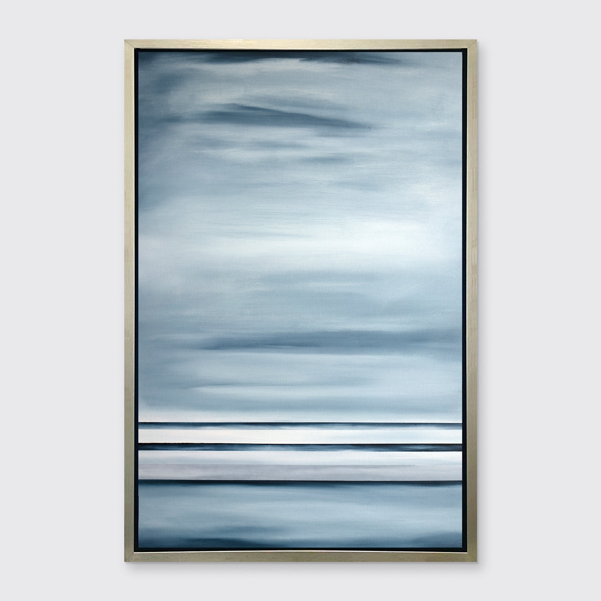 Blue and white geometric abstract print in a silver floater frame on a white wall.
