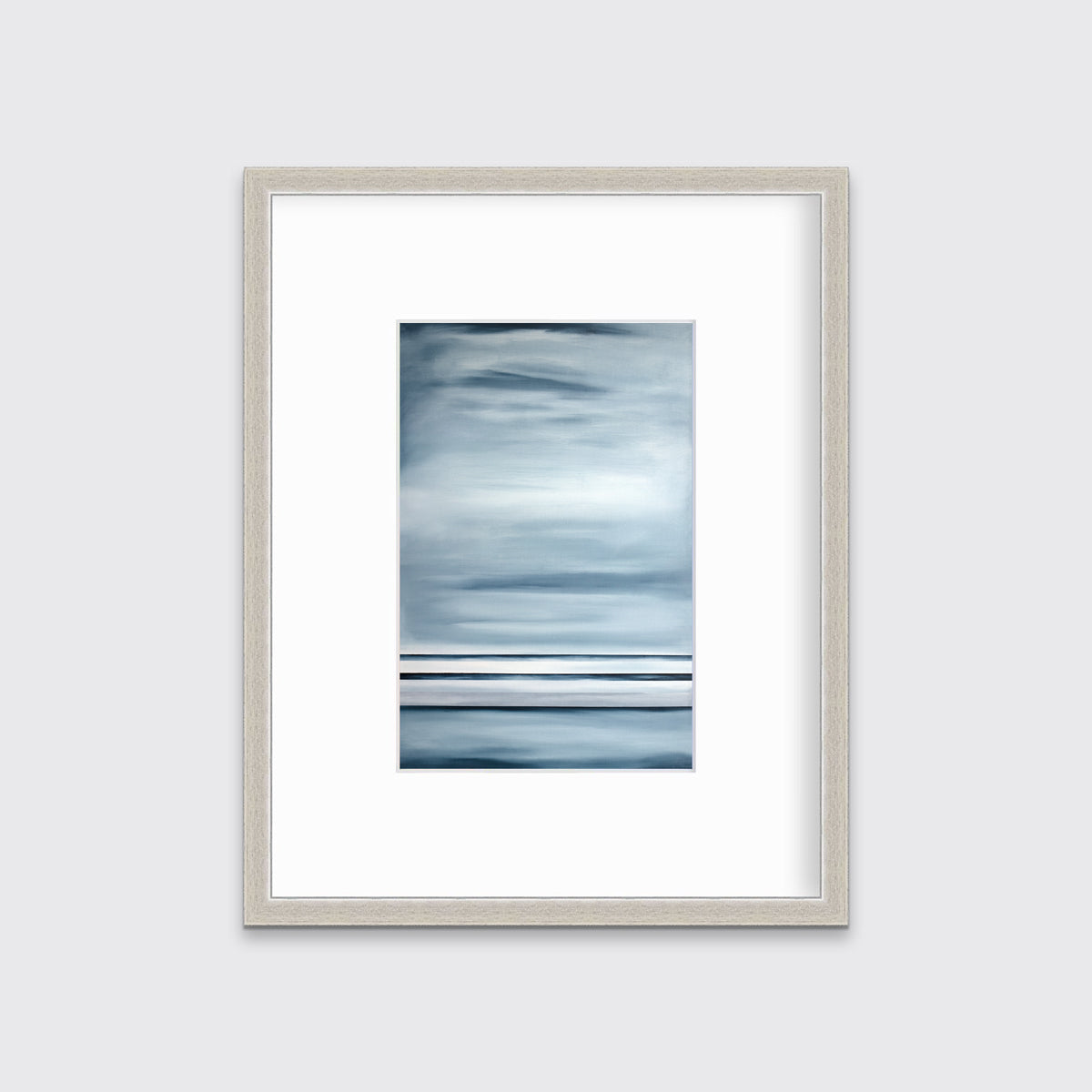 Blue-grey linear abstract print in a silver frame with a mat on a white wall.