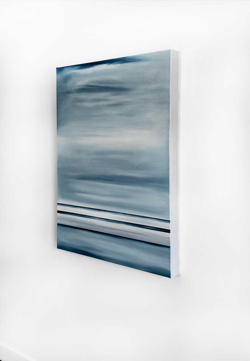 A right side-angle view of a blue-grey abstract painting hanging on a white wall.