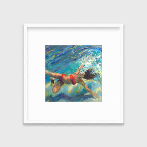 An abstract figurative print of a woman in a red bikini floating underwater in a white frame with a mat hangs on a white wall.