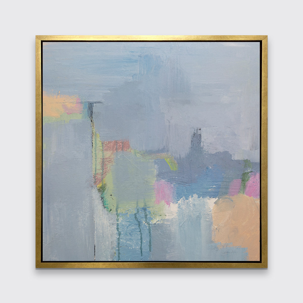 A slate blue, green, light orange and pink abstract print in a gold floater frame hangs on a white wall.