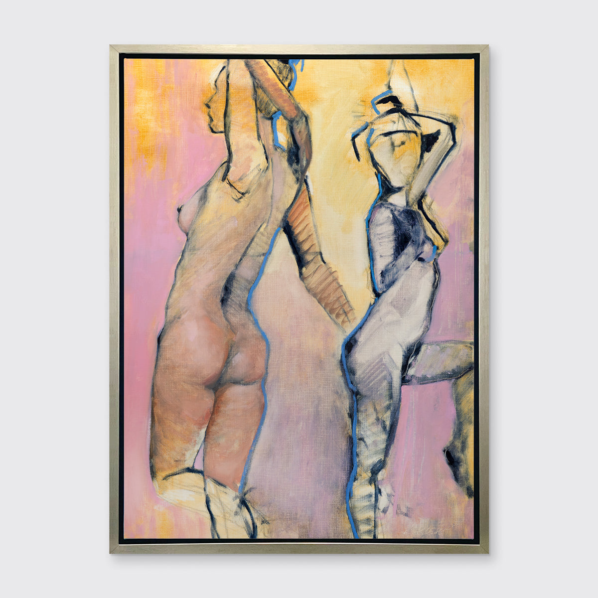 A pink, yellow, blue and black abstract figurative print of two women in a silver floater frame hangs on a white wall.
