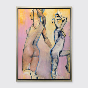 A pink, yellow, blue and black abstract figurative print of two women in a silver floater frame hangs on a white wall.