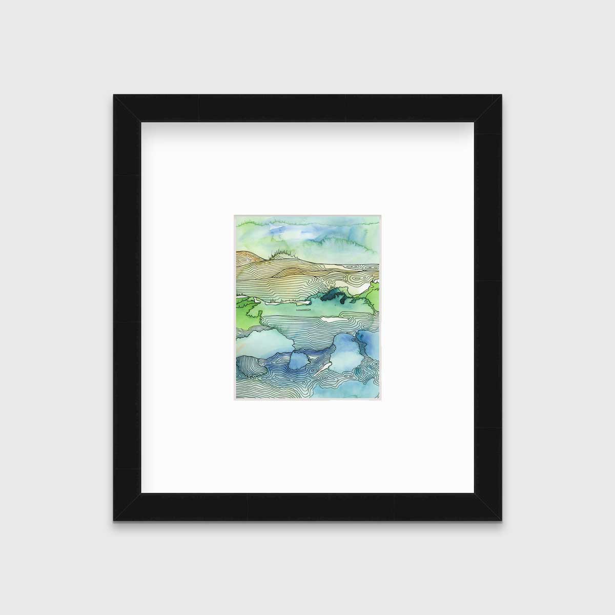 A green and blue landscape illustration print framed in a black frame with a mat hangs on a light grey wall.