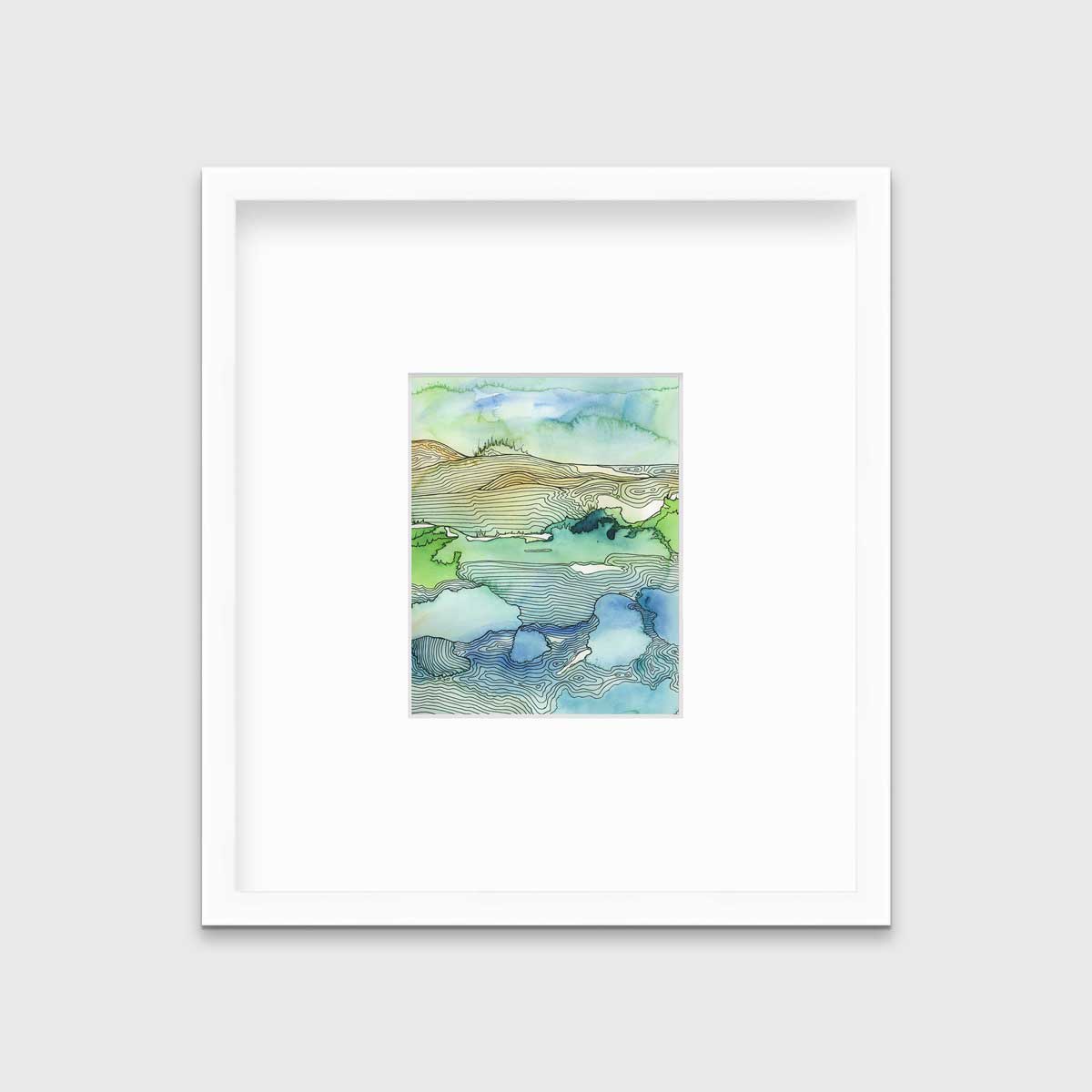 A green and blue landscape illustration print framed in a white frame with a mat hangs on a light grey wall.