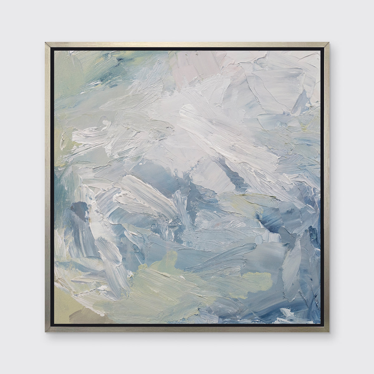 A white, blue, grey and light green abstract print in a silver floater frame hangs on a white wall.