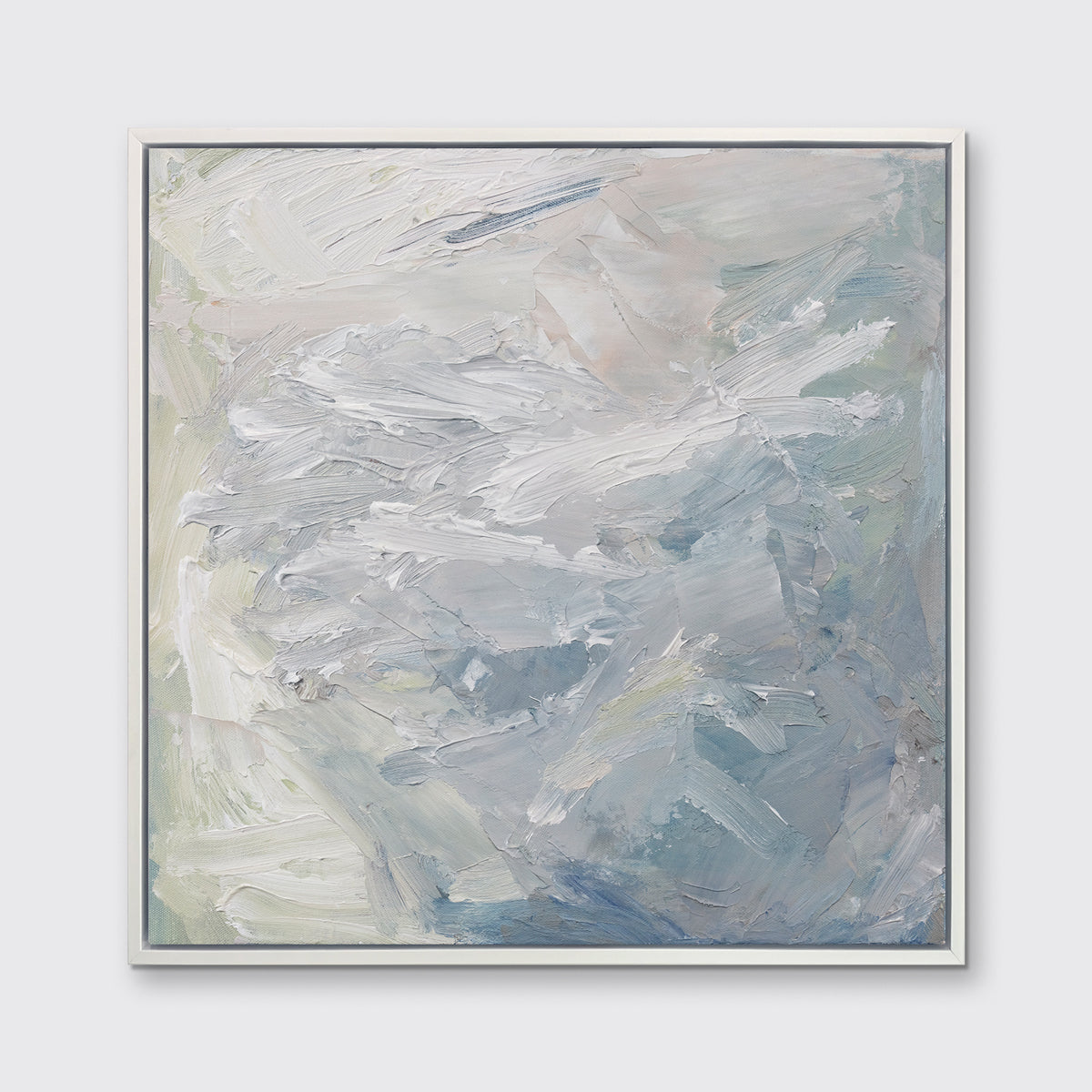 A white, blue, grey and light green abstract print in a white floater frame hangs on a white wall.
