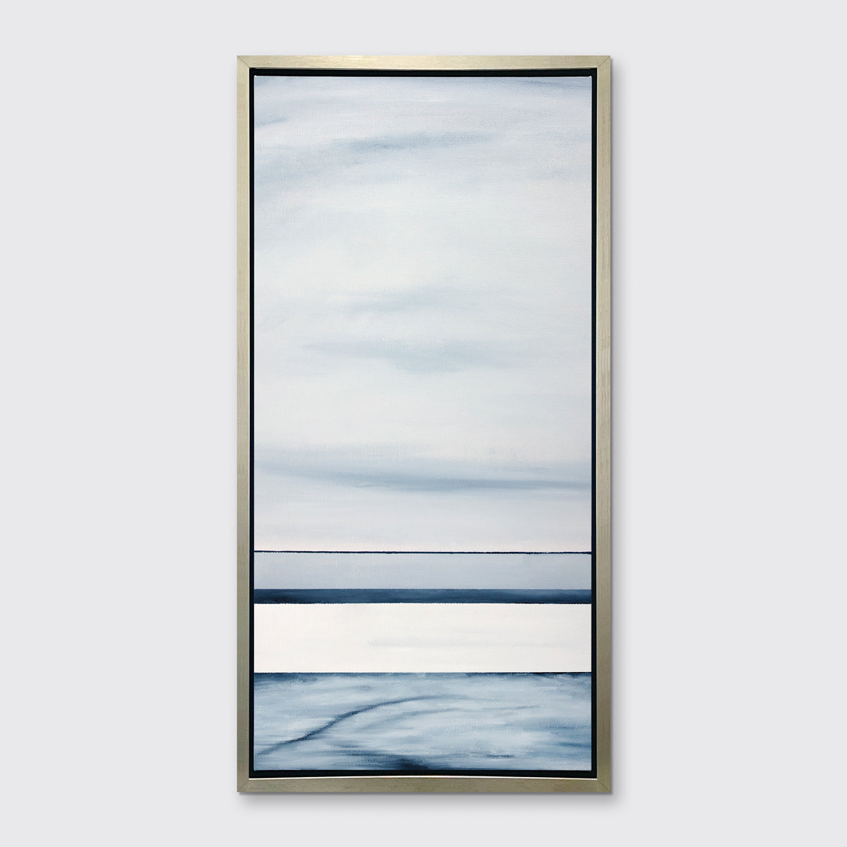 A blue-grey linear abstract print in a silver floater frame hangs on a white wall.