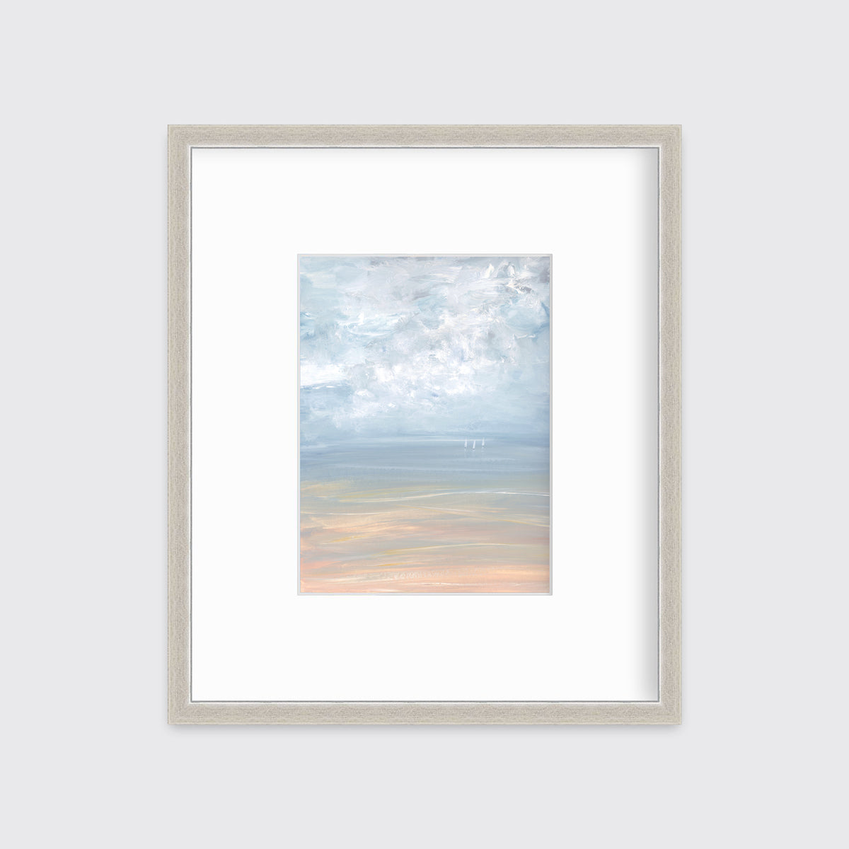 A white, blue and beige abstract seascape print in a silver frame with a mat hangs on a white wall.
