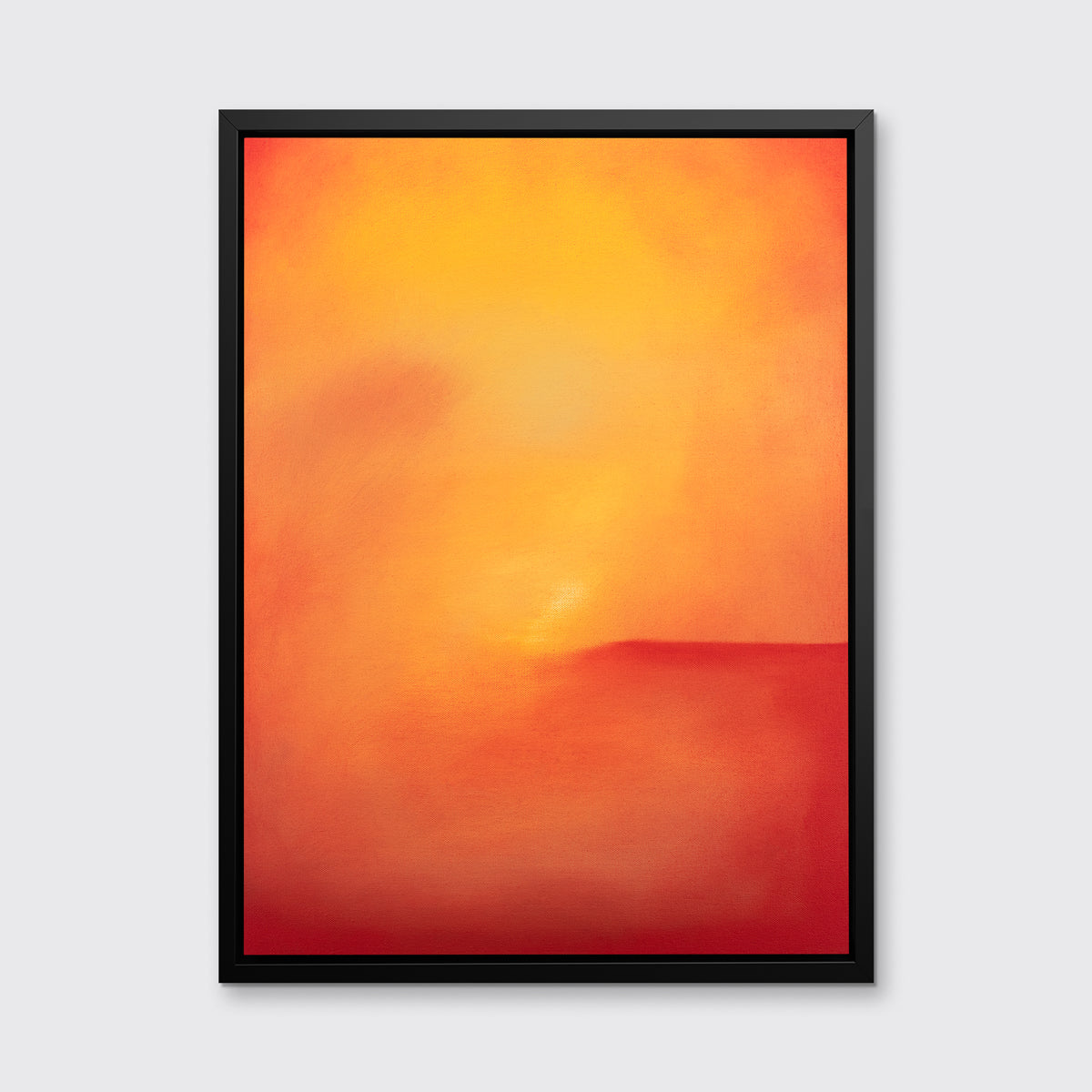 An orange and red abstract print in a black floater frame hangs on a white wall.