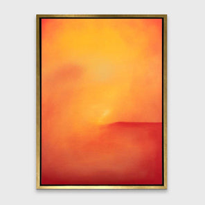 An orange and red abstract print in a gold floater frame hangs on a white wall.