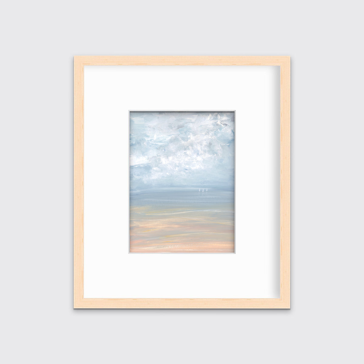 A white, blue and beige abstract seascape print in a natural wood frame with a mat hangs on a white wall.