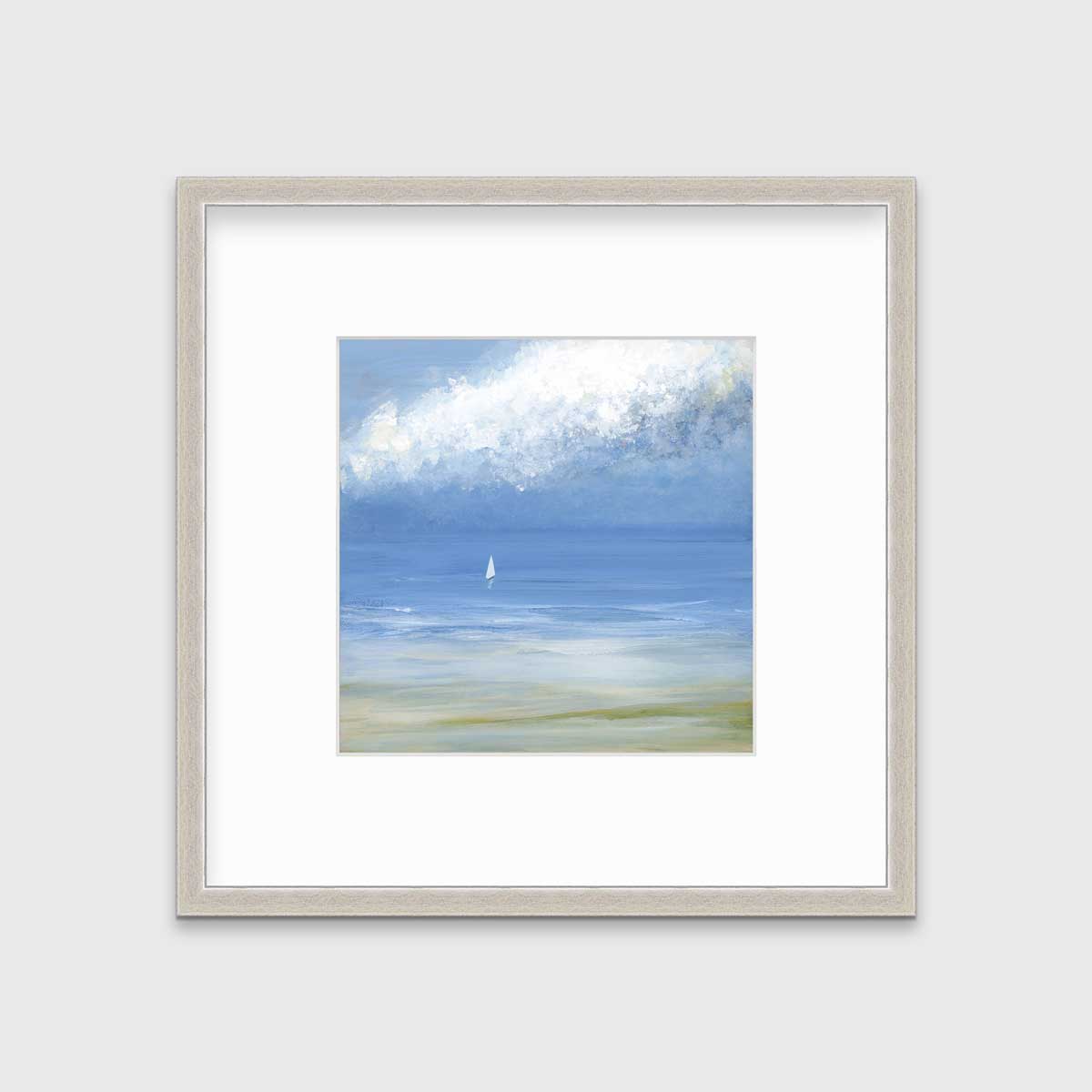 A blue, light green and white abstract seascape print with a small sailboat in a silver frame with a mat hangs on a white wall.