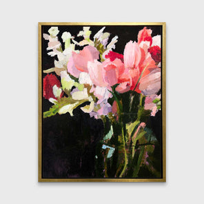A pink, black and green abstract floral print in a gold floater frame hangs on a white wall.