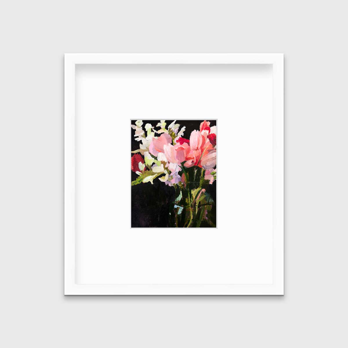 A pink, black and green abstract floral print in a white frame with a mat hangs on a white wall.