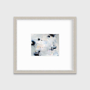 A black and white abstract print by Kelly Rossetti hangs in a silver frame with a mat on a white wall.