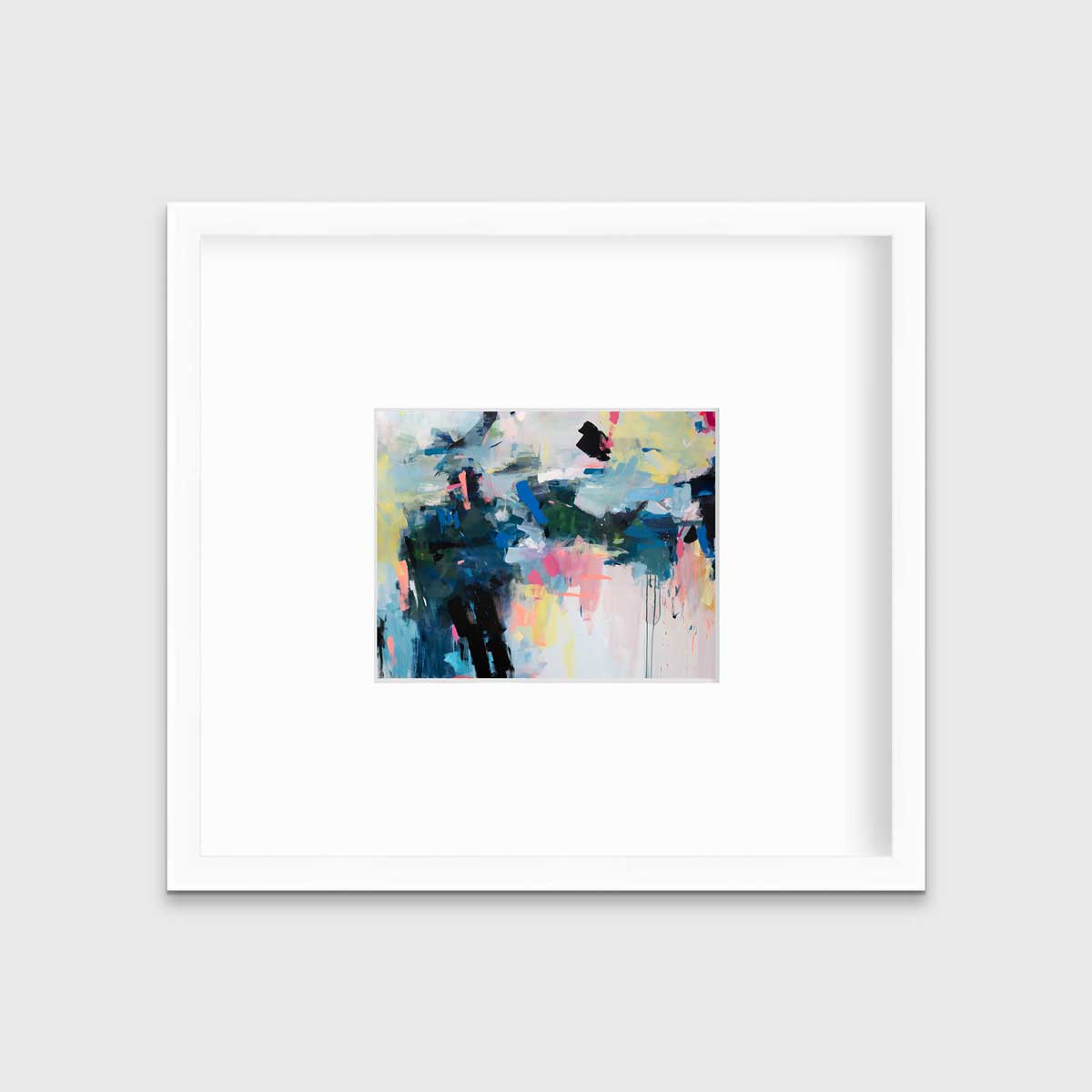 A colorful abstract print by Kelly Rossetti in a white frame with a mat hangs on a white wall.