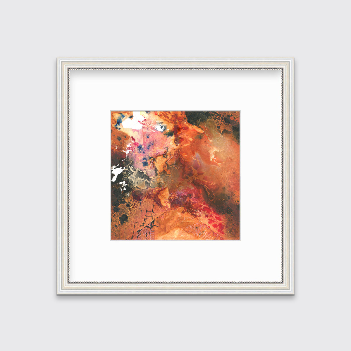 A red, orange, black and pink abstract print in a white frame with antiqued beading with a mat hangs on a white wall.