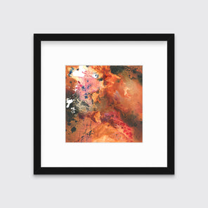A red, orange, black and pink abstract print in a black frame with a mat hangs on a white wall.