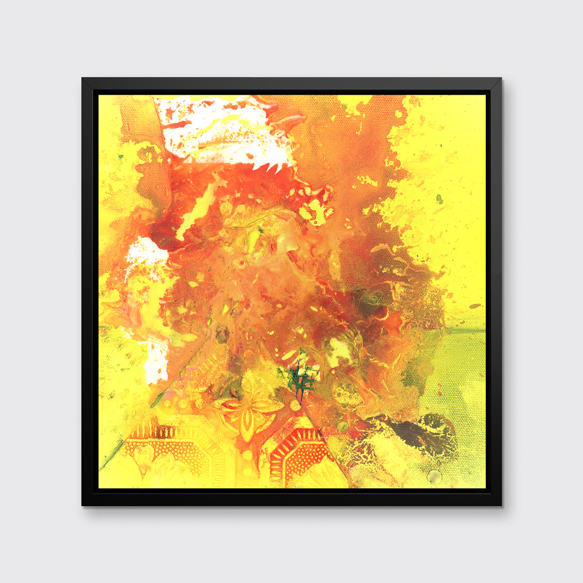 A yellow, orange and white abstract print in a black floater frame hangs on a white wall.