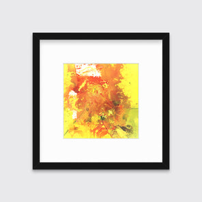 A yellow, orange and white abstract print in a black frame with a mat hangs on a white wall.