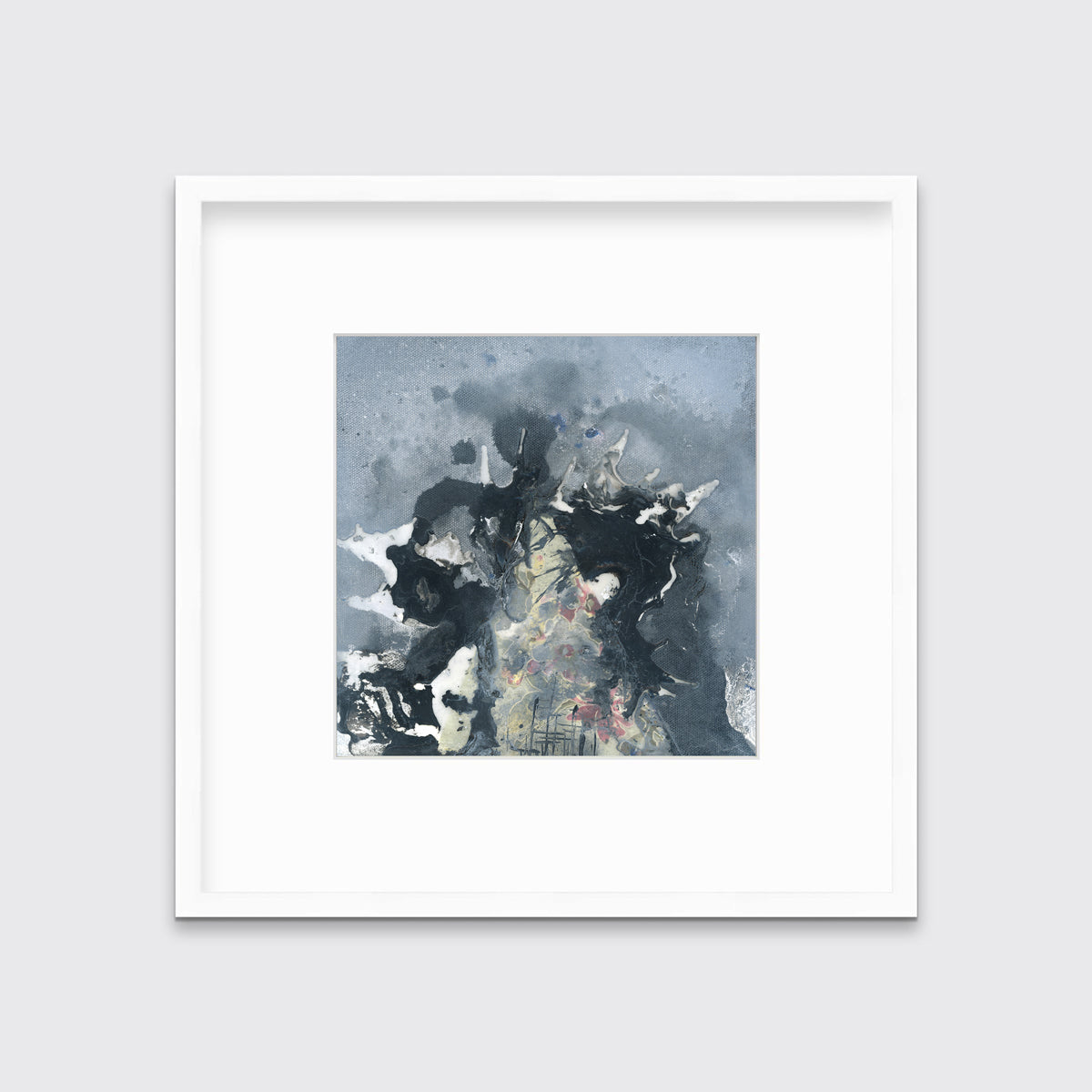 A grey, black, white and light yellow abstract print in a white frame with a mat hangs on a white wall.