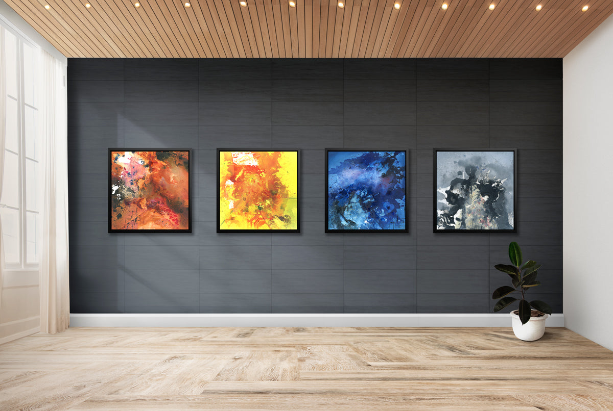 A series of four prints in different colors in black floater frames hang on a black wall.