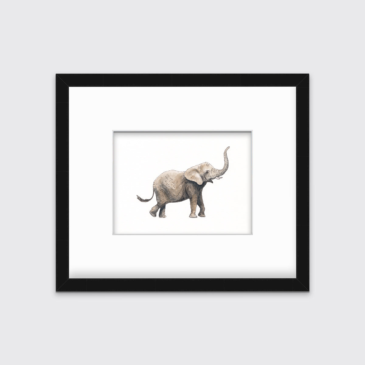 An elephant print in a black frame with a mat hangs on a white wall.