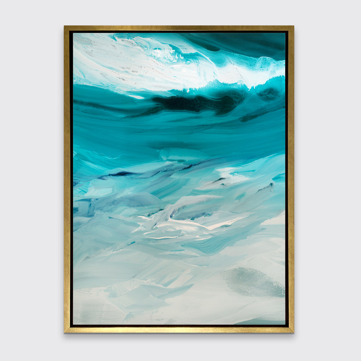 A teal, white and grey abstract print in a gold floater frame hangs on a white wall.