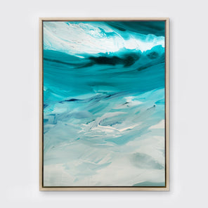 A teal, white and grey abstract print in a white oak floater frame hangs on a white wall.