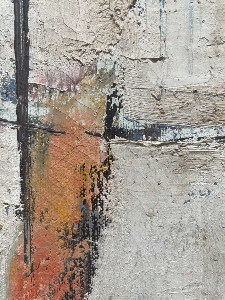 A close up of the texture of the white, orange and black paint.