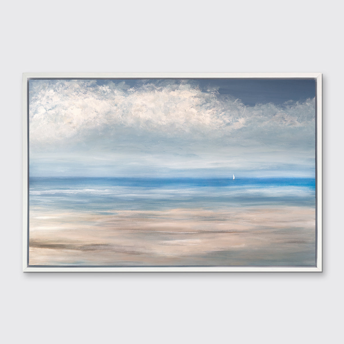 A blue, white and beige seascape print in a white floater frame hangs on a white wall.